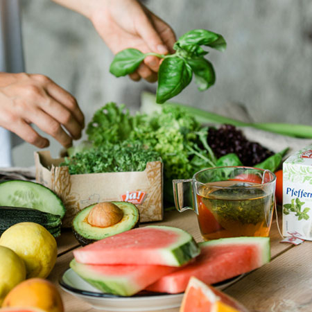 Aufgeschnittene Bio-Melone, Avocado, Balsamico, Kresse und Salat.