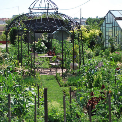 Ein Garten mit einem Gewächshaus.