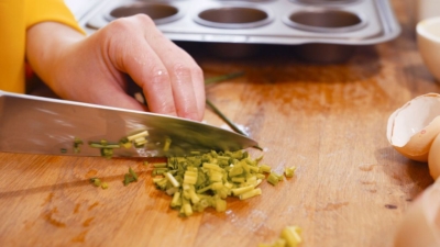 Jemand schneidet Bio-Schnittlauch.
