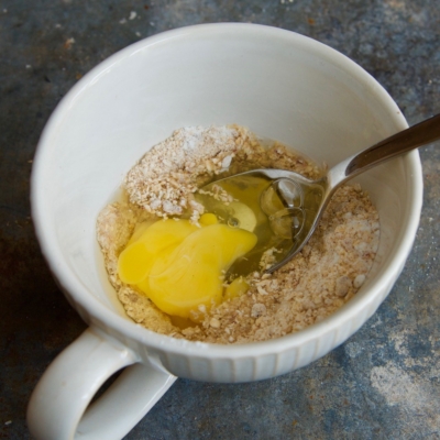 Ein Bio-Ei, vermengt mit Backpulver, in einer Tasse.