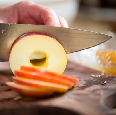 Jemand schneidet Äpfel in Scheiben.