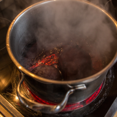 Rote Bio-Rüben werden in einem Topf gekocht.
