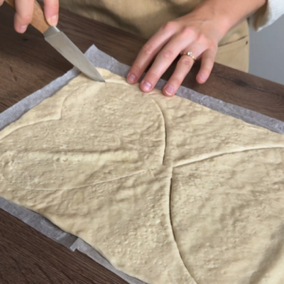 Pizzateig wird in Herzform ausgeschnitten