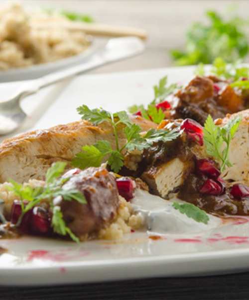 Bio-Hühner-Tajine mit Granatapfel, Minz-Joghurt und Rauchmandel-Couscous.