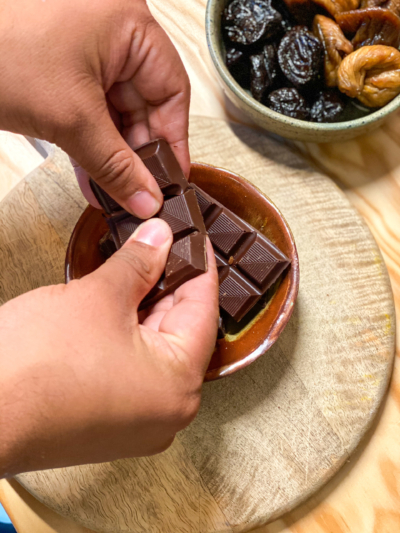 Jemand bricht Bio-Schokolade.