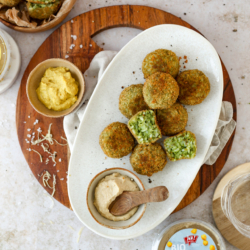 Reisbällchen mit Bio-Spinat auf einem Teller.